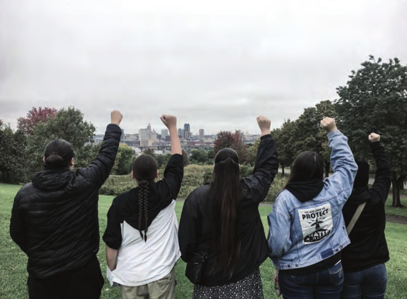 Group of students holding up their fists
